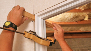 Installing trim and finishing touches to a remodeled basement in Stamford, CT, NY & MA